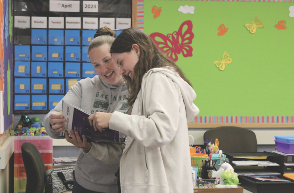 Working as a teacher’s aide at Greenbriar Elementary School, senior Maddie Cole meets with fifth-grade teacherp Jessica Sliepka to prepare for a class lesson about science. Students in the Teaching Internship course lead students, grade assignments and teach lessons.
